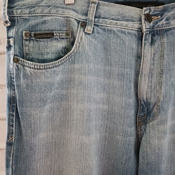 Calvin Klein • Men's Light/Medium Wash Distressed Bootcut Denim Jeans - Picture 4 of 15